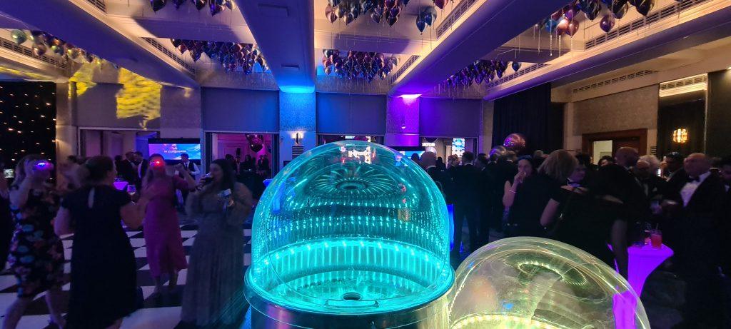 Glowing candy floss station active at an evening gala party