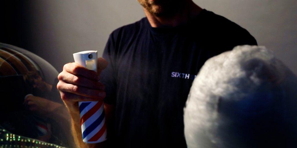 Event bartender misting gourmet flavour essence onto spun candy floss