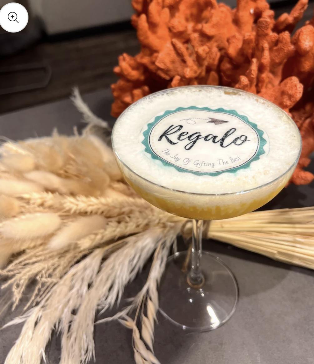 Bespoke edible branded logo cocktail topper on freshly shaken craft cocktail