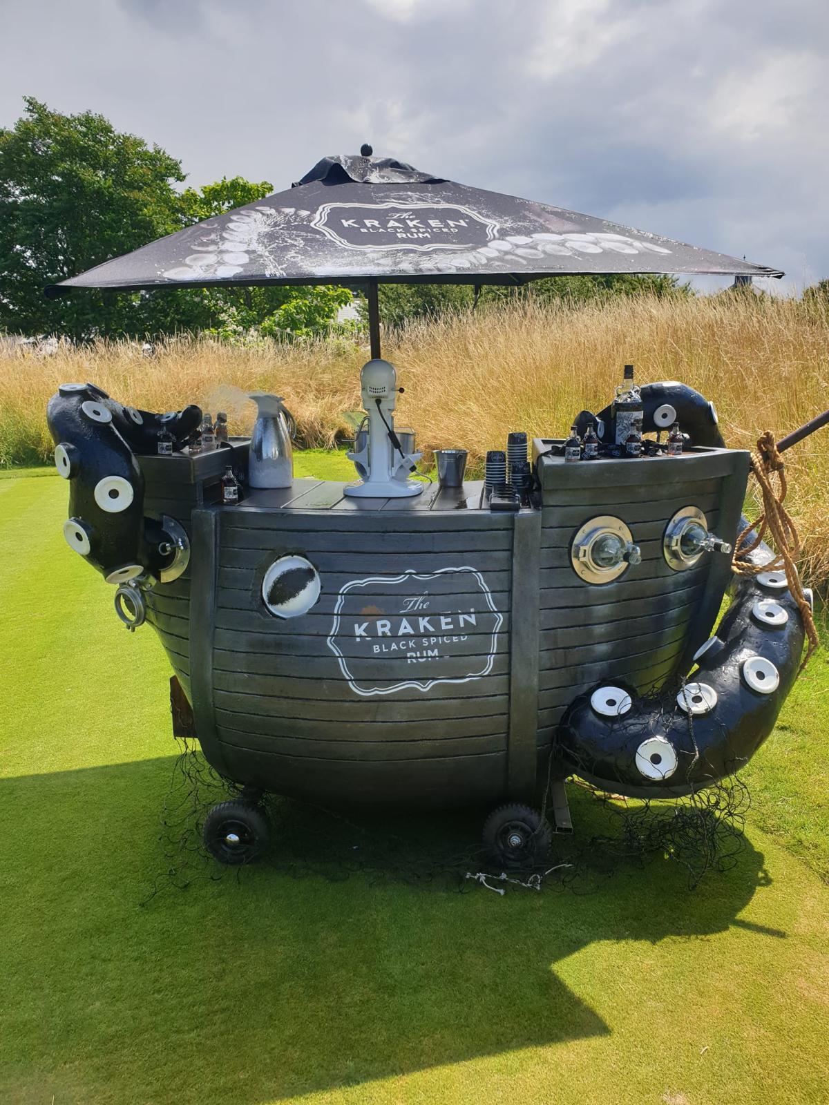 Custom Kraken Rum ship cart with giant 3D octopus tentacles and liquid nitrogen mixer outdoors