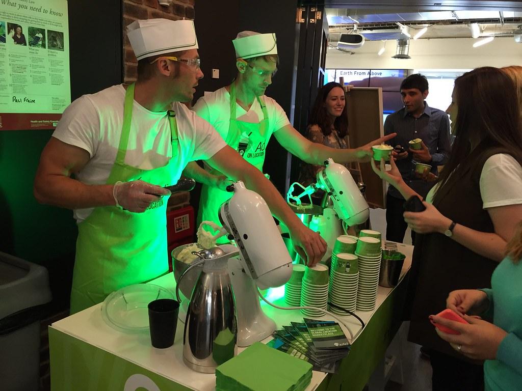 Chefs in green aprons and retro hats serving corporate guests at xAd nitrogen ice cream cart