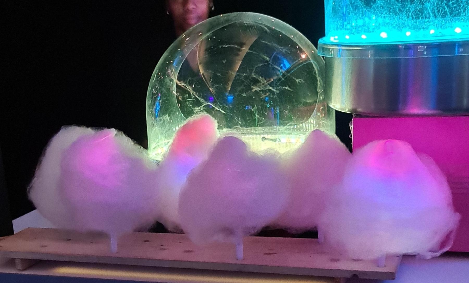Illuminated neon candy floss bar cart with glowing candy floss cones