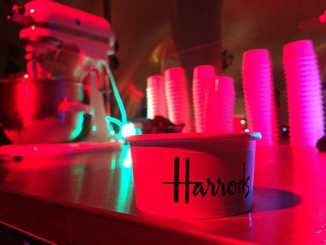 Harrods branded dessert cup under red festive lighting at corporate Christmas party