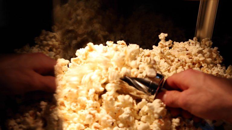 Scooping freshly popped warm popcorn before nitrogen flash-freeze