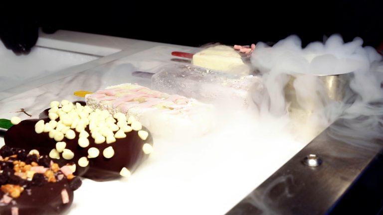 Flash-frozen ice lollies with chocolate dips and toppings displayed on sub-zero cold plate