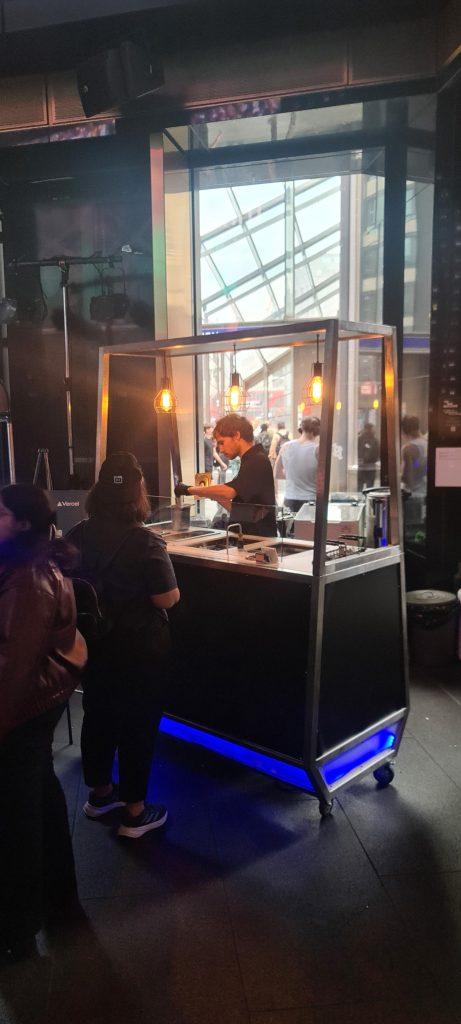 Sleek black branded ice lolly bar with ambient lighting at Vercel technology summit