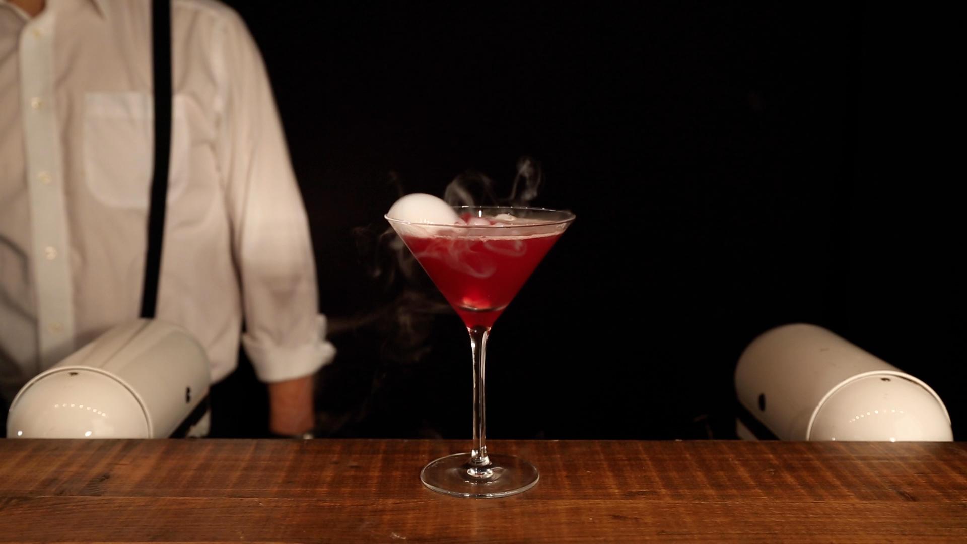 Molecular mixology cocktail topped with a scented aroma vapour bubble on mobile bar counter